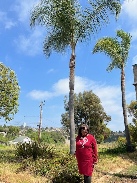 Rosemary Pope, with the two palms outside George Stevens Senior Center. (Jan Goldsmith)