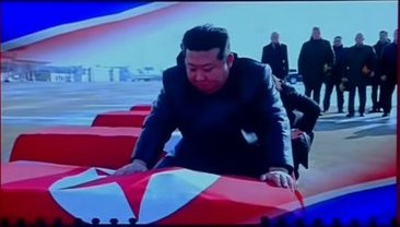 Kim Jong-un draping North Korean flags over coffins.