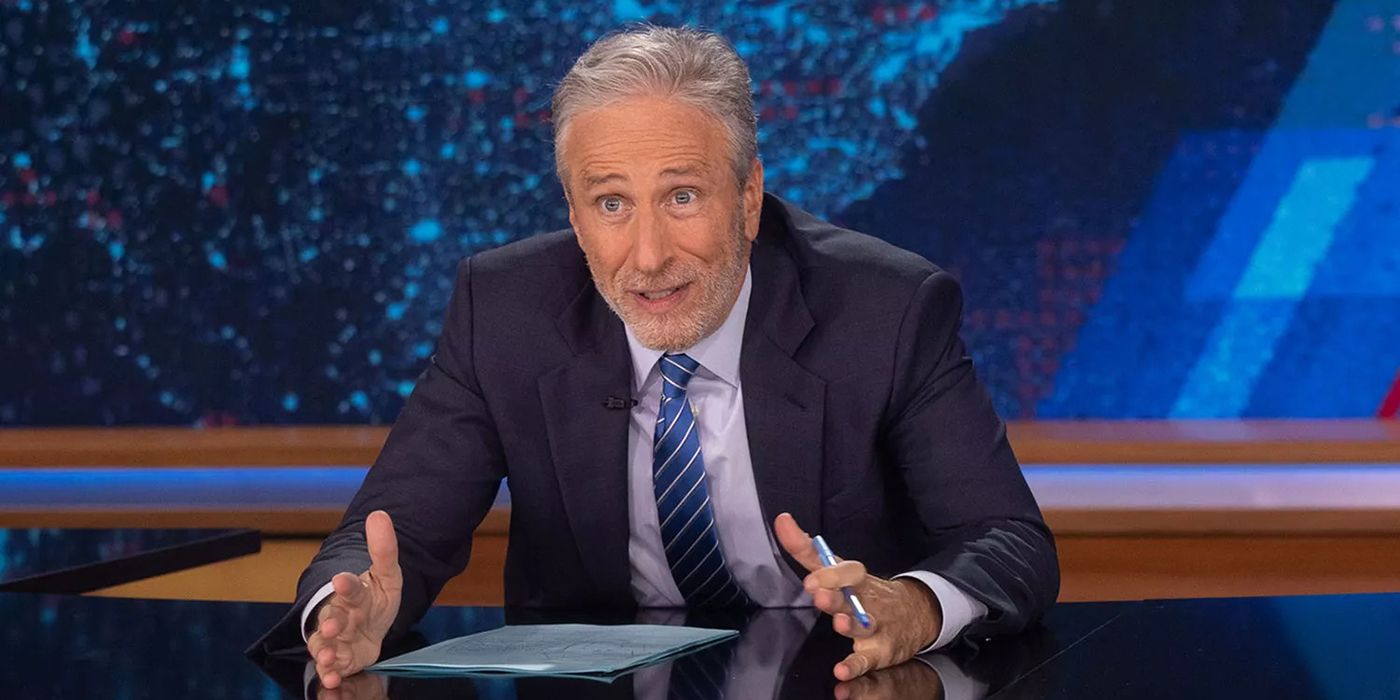 Jon Stewart with his hands out talking animatedly on The Daily Show.