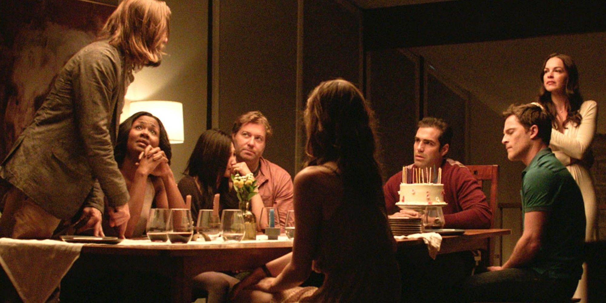 The cast of The Invitation gather around a dinner table