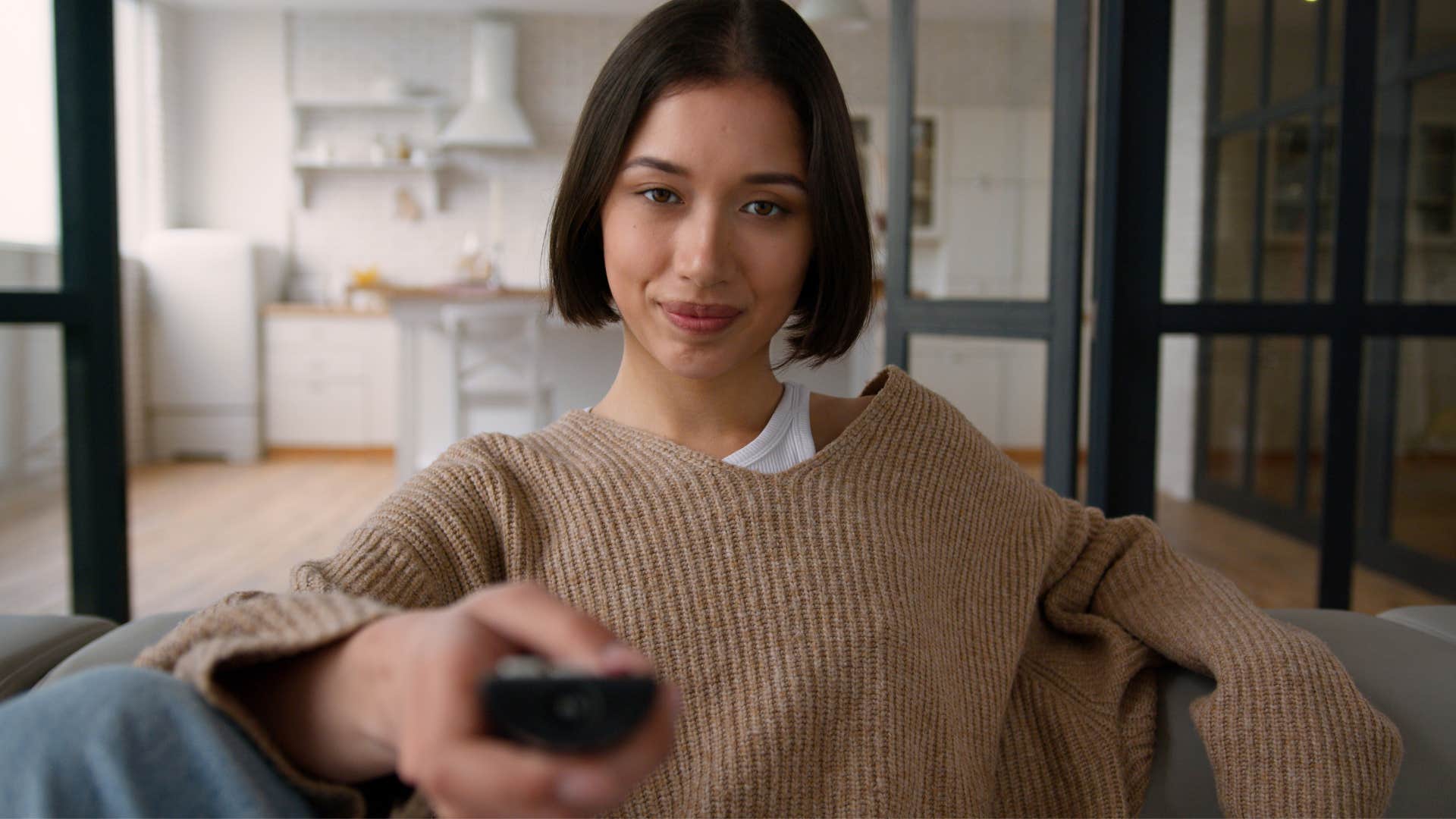 rich woman scrolling endless subscriptions on her tv