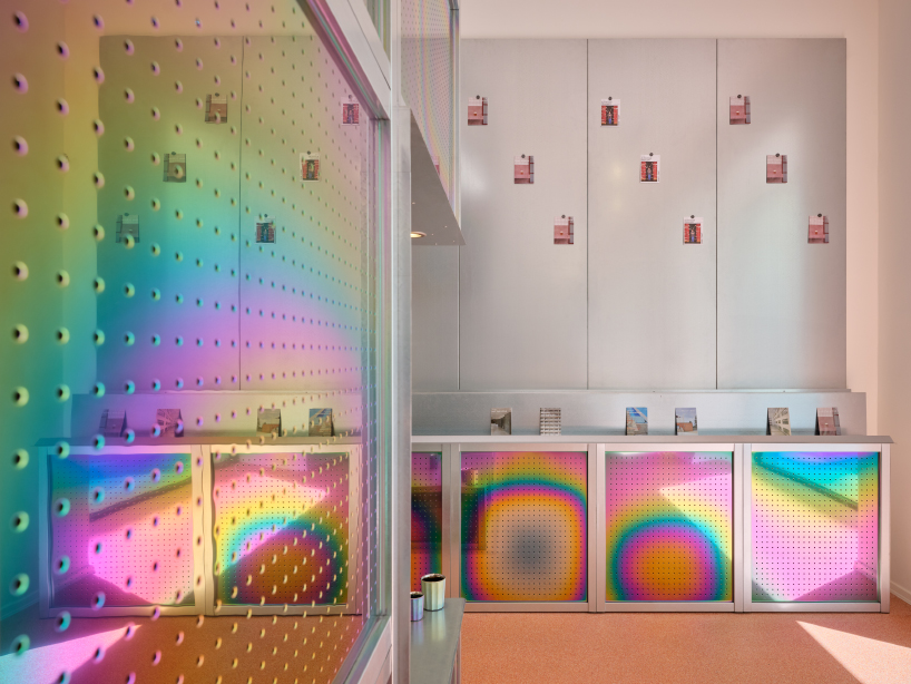 iridescent titanium panels cast chromatic reflections within info desk by KOGAA in brno