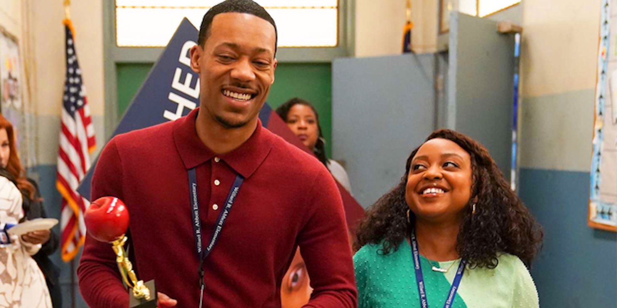 Tyler James Williams' Gregory and Quinta Brunson's Janine smile and laugh in the hallways from Abbott Elementary