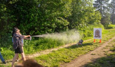 At this safety demo, Anchorage residents aim their bear spray at a foam target