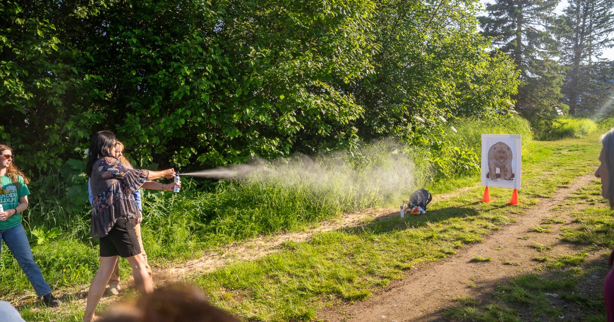 At this safety demo, Anchorage residents aim their bear spray at a foam target