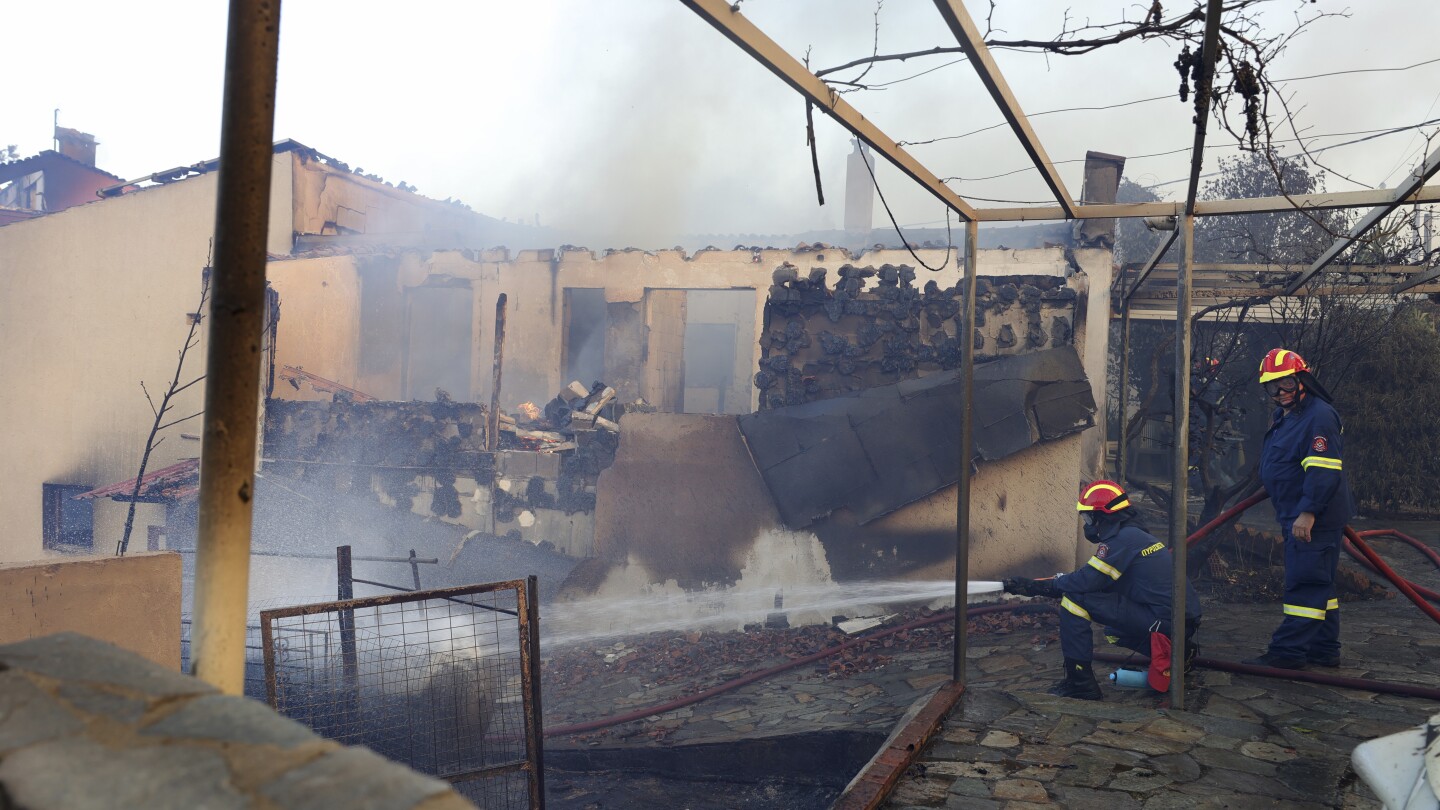 Wildfire burns through suburb of Greece's capital Athens and residents told to evacuate