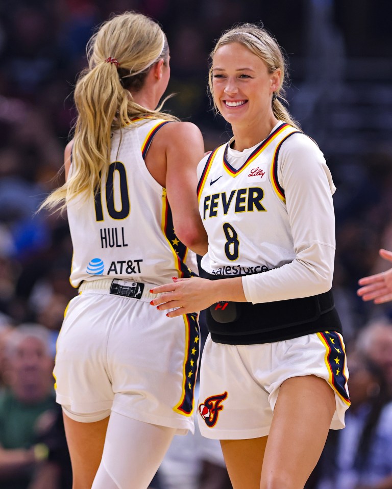 Indiana Fever players Lexie Hull (#10) and Sophie Cunningham (#8) embracing.