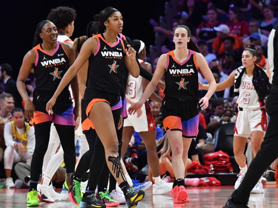 Three WNBA All-Stars walking on the court.