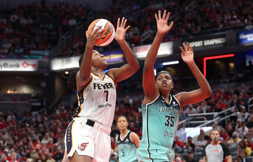 Aliyah Boston #7 of the Indiana Fever shooting a basketball, defended by Jonquel Jones #35 of the New York Liberty.
