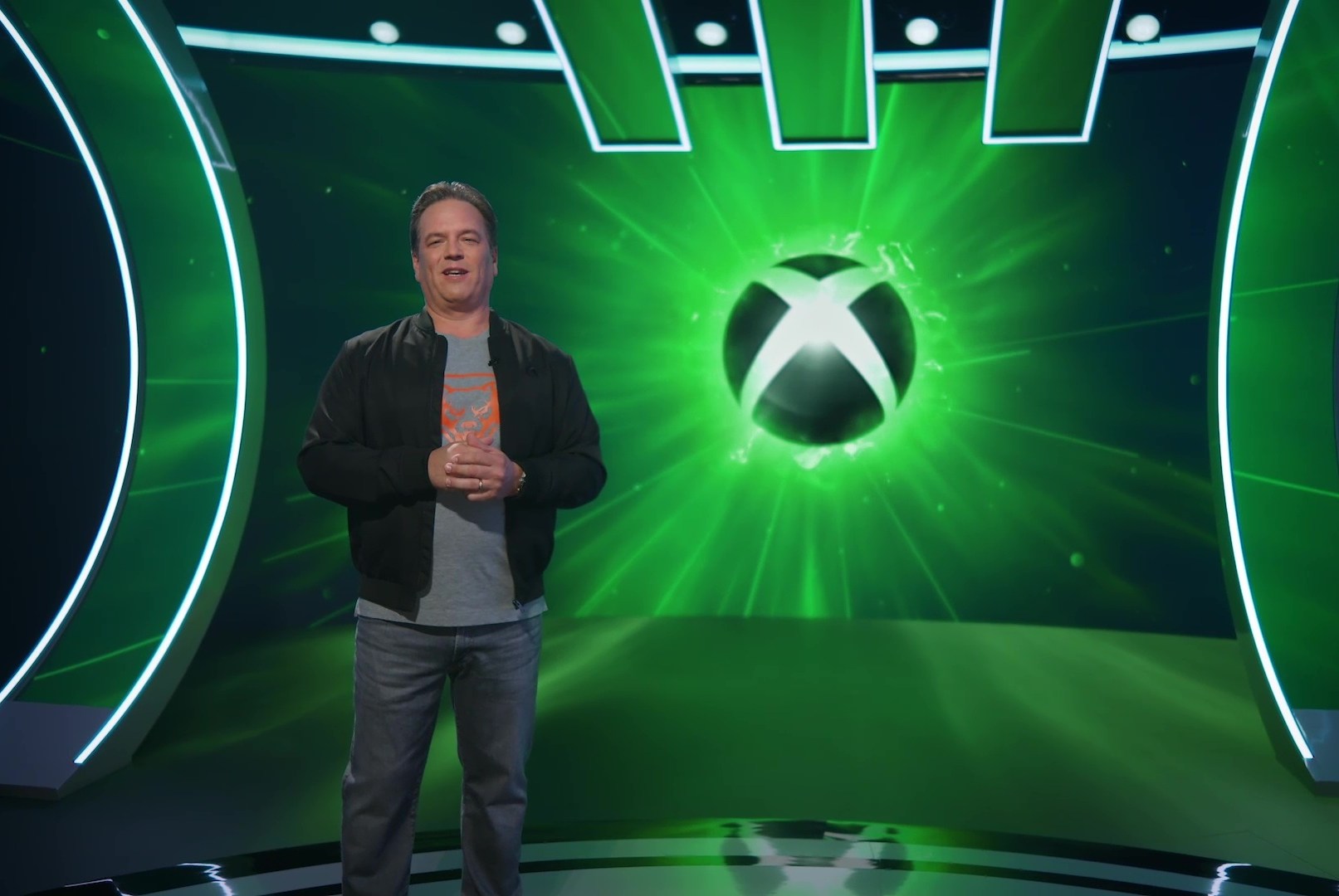 Phil Spencer stands in front of the Xbox logo for the pre-recorded Xbox Games Showcase in 2024.
