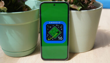 The Android 16 logo on a Google Pixel 8a outdoors.