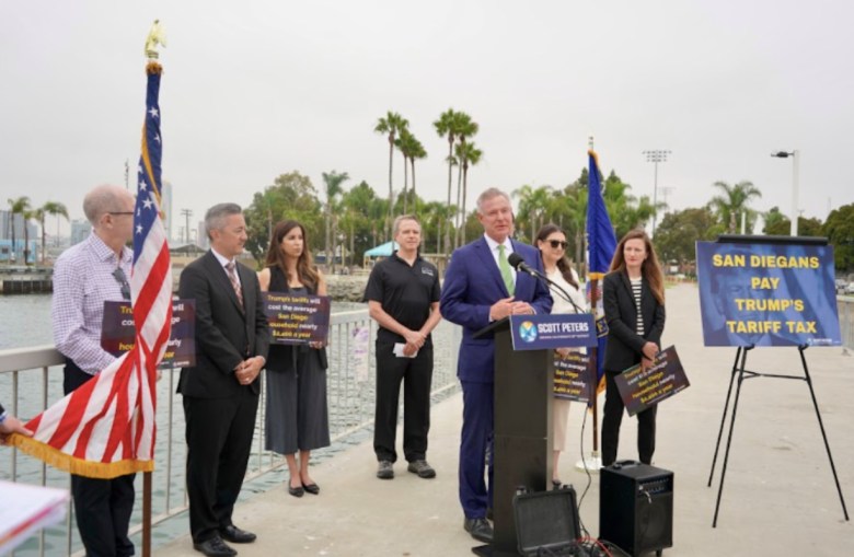 Rep. Scott Peters, flanked by colleague Rep. Sara Jacobs (to his left) and executives and advocates for San Diego's business community. They came together to raise concerns about tariffs.