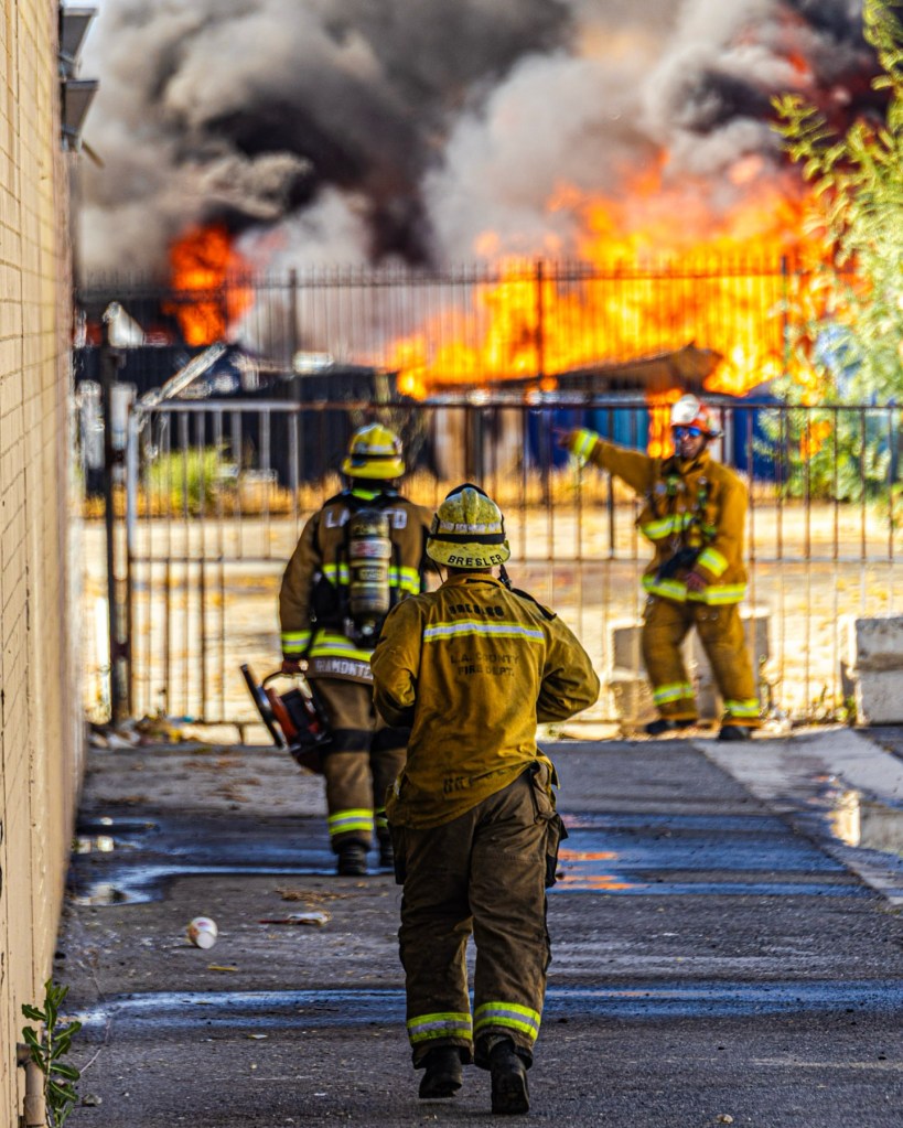 Firefighters battling a large fire.