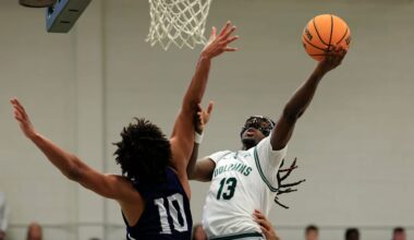 Jacksonville Dolphins guard Robert McCray V (13) drives the lane against North Florida Ospreys forward Josh Harris (10) during the first half of an NCAA men’s basketball matchup Saturday, Feb. 1, 2025 at Jacksonville University in Jacksonville, Fla. [Corey Perrine/Florida Times-Union]
