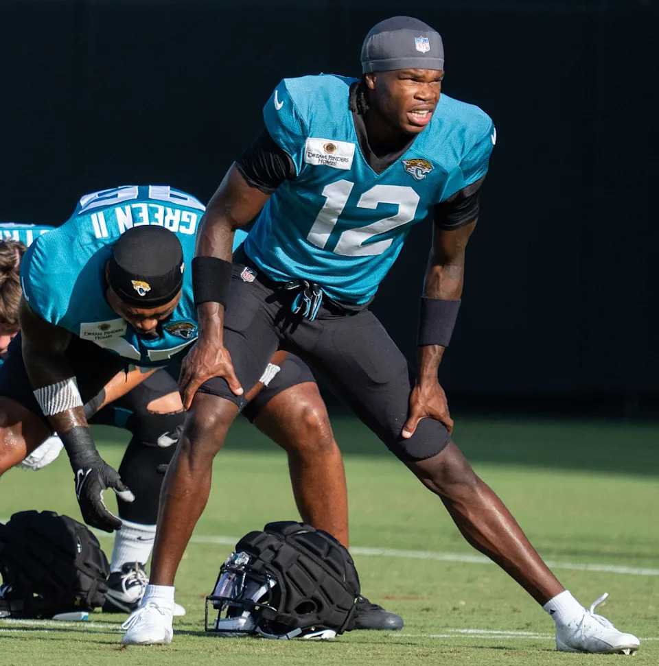 Jacksonville Jaguars wide receiver Travis Hunter (12) stretches during the Jaguars 14th NFL training camp session at Miller Electric Center Tuesday August 12, 2025 in Jacksonville, Fla. The Jaguars travel to New Orleans to play the Saints this Sunday in their second preseason game. [Doug Engle/Florida Times-Union]