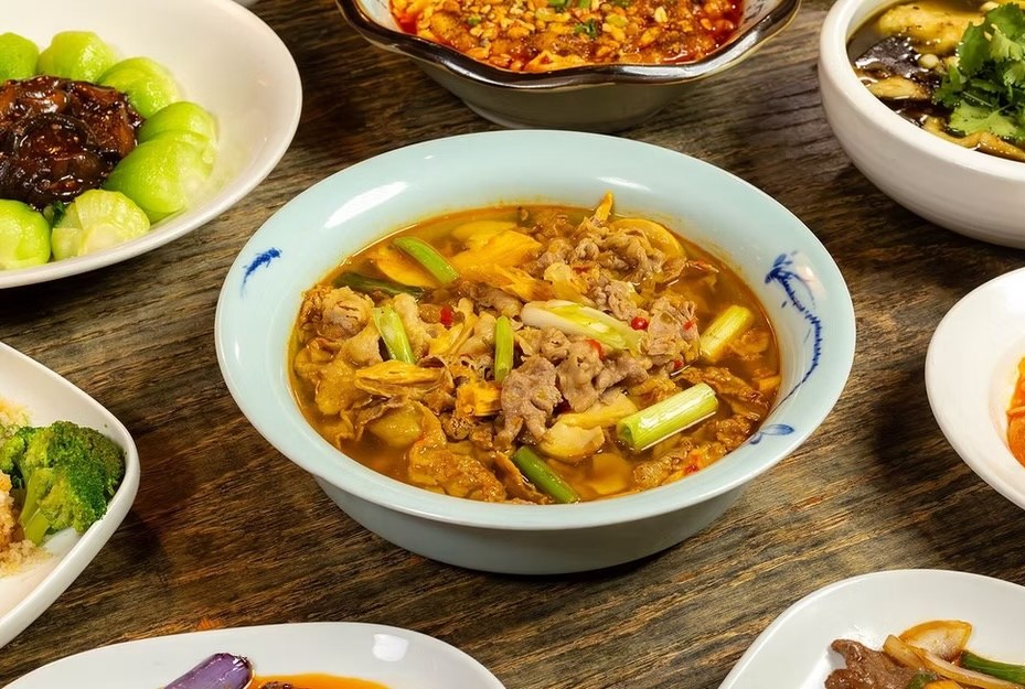A soupy chicken dish served in a bowl.
