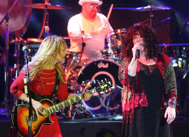 Heart's Nancy Wilson and Ann Wilson, from left, are joined by drummer Jason Bonham during their set at the Greek Theatre in Los Angeles in August 2013.Photo by ARMANDO BROWN, FOR THE REGISTER