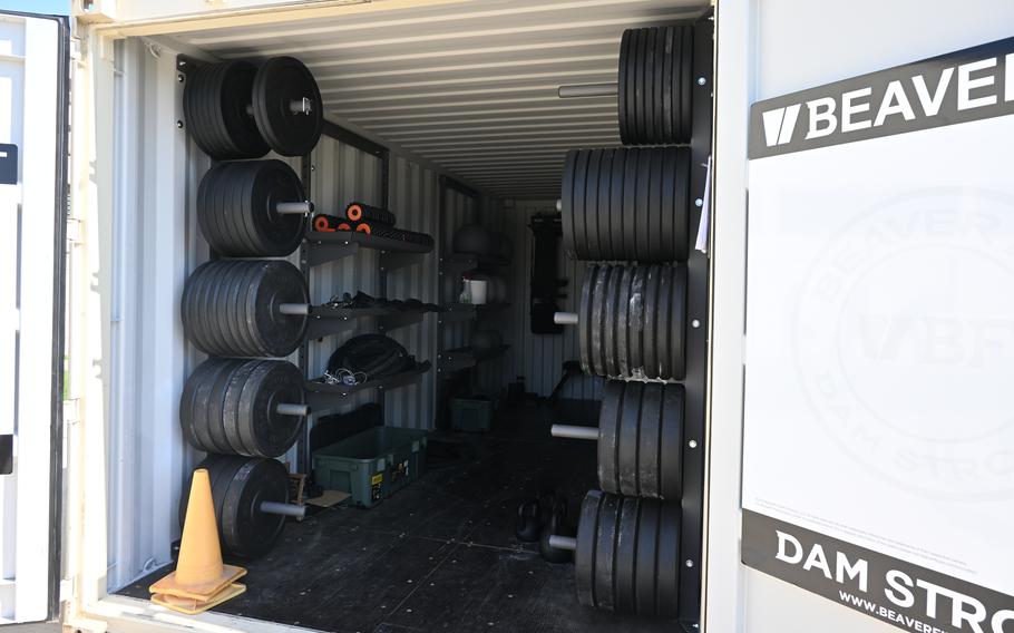 Exercise equipment is stored in a large metal container.