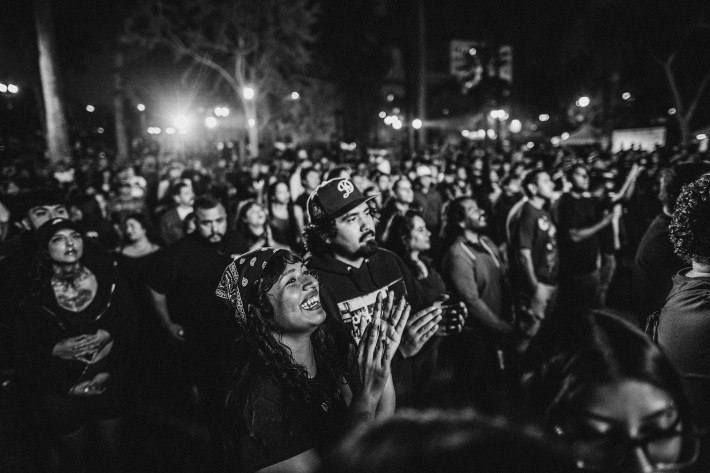 The crowd gathers as La Resistencia sets up in MacArthur Park on August 16, 2025.