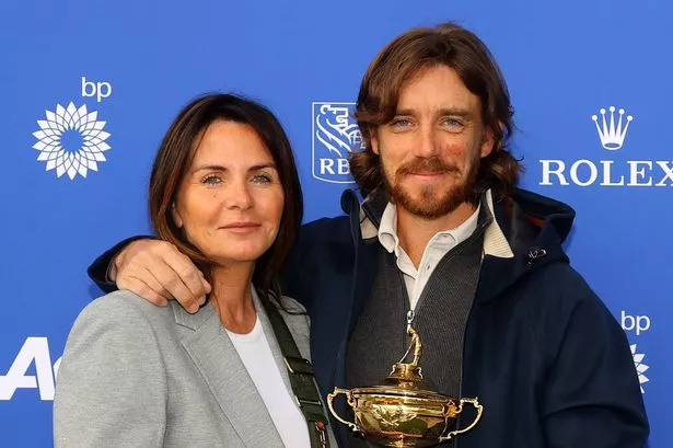 Tommy Fleetwood and his wife Clare pose with the Ryder Cup trophy