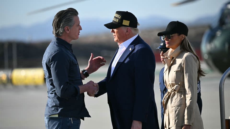 President Donald Trump, followed by first lady Melania Trump, shakes hands with California Gov. Gavin Newsom after arriving at Los Angeles International Airport in Los Angeles on January 24 to visit the region devastated by the Palisades and Eaton fires. - Mandel Ngan/AFP/Getty Images