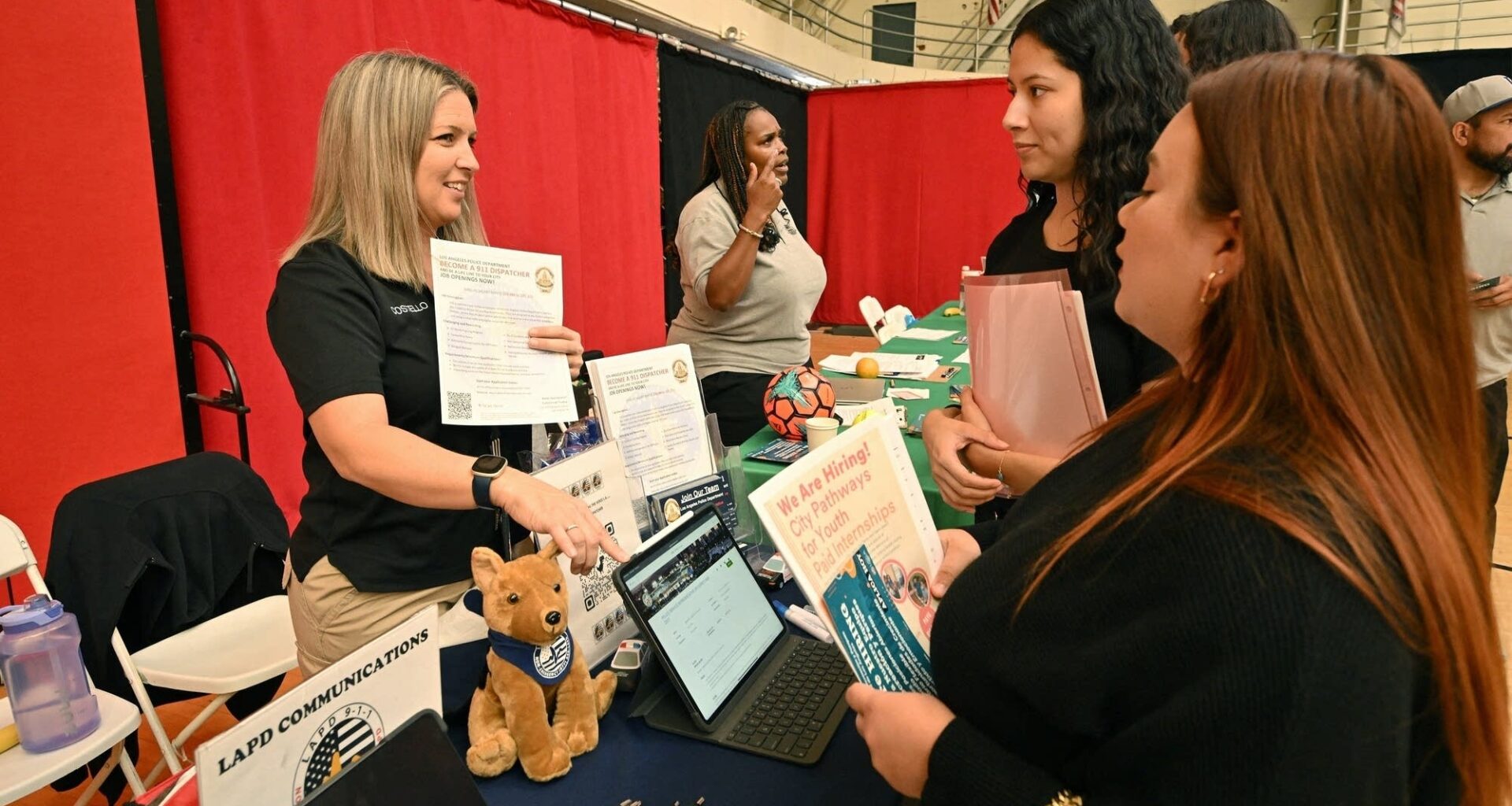 Job seekers speak with prospective employers during a career fair in Los Angeles.