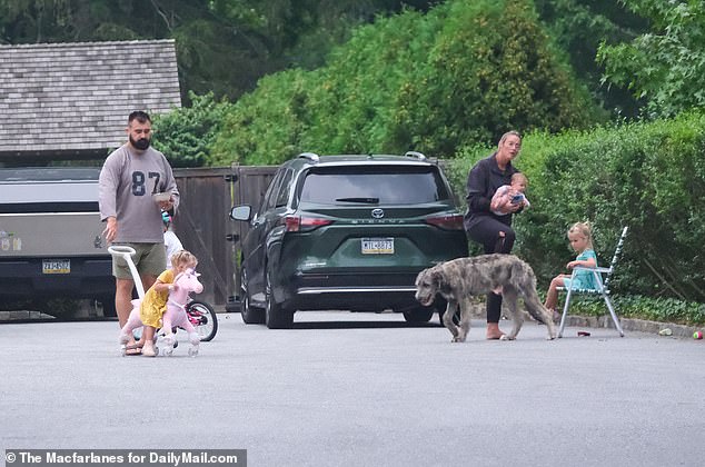 The former center cut a casual figure as he and Kylie watched over their four daughters