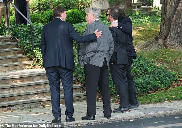 The Kelce patriarch is comforted by fellow mourners as Maguire's friends and family filter out