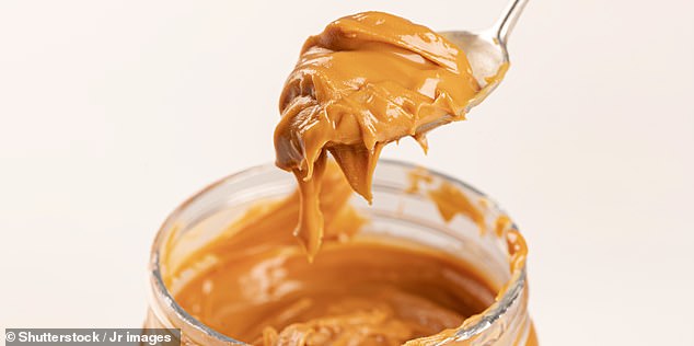 A team of experts from the University of Barcelona got 58 young, healthy volunteers to either snack on 25g of peanuts every day for six months, or a daily serving of peanut butter (Stock photo)