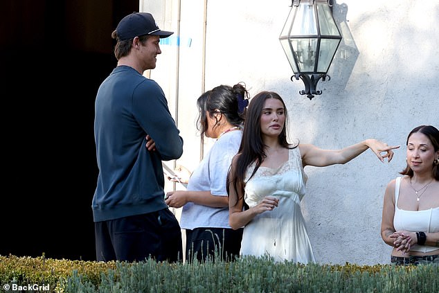 The singer and Los Angeles Chargers quarterback were pictured chatting between filming