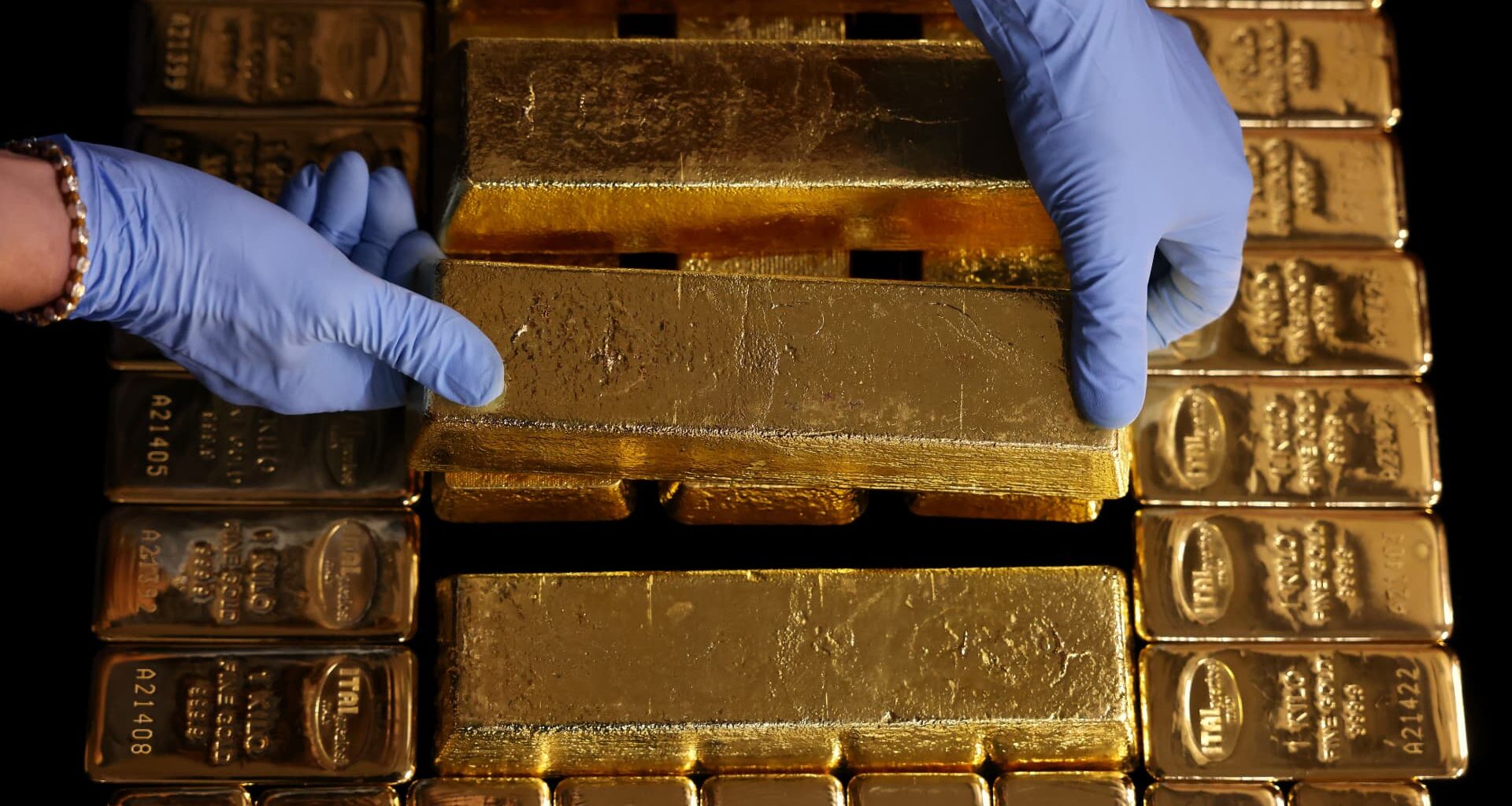 Gold inches lower as dollar gains, markets eye Fed appointments