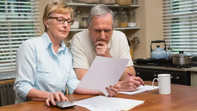 Seniors looking at paperwork.