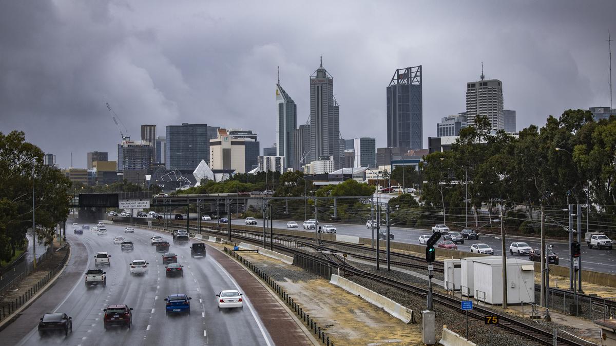 Perth shivers through coldest day in 50 years as residents marvel at rain, hail