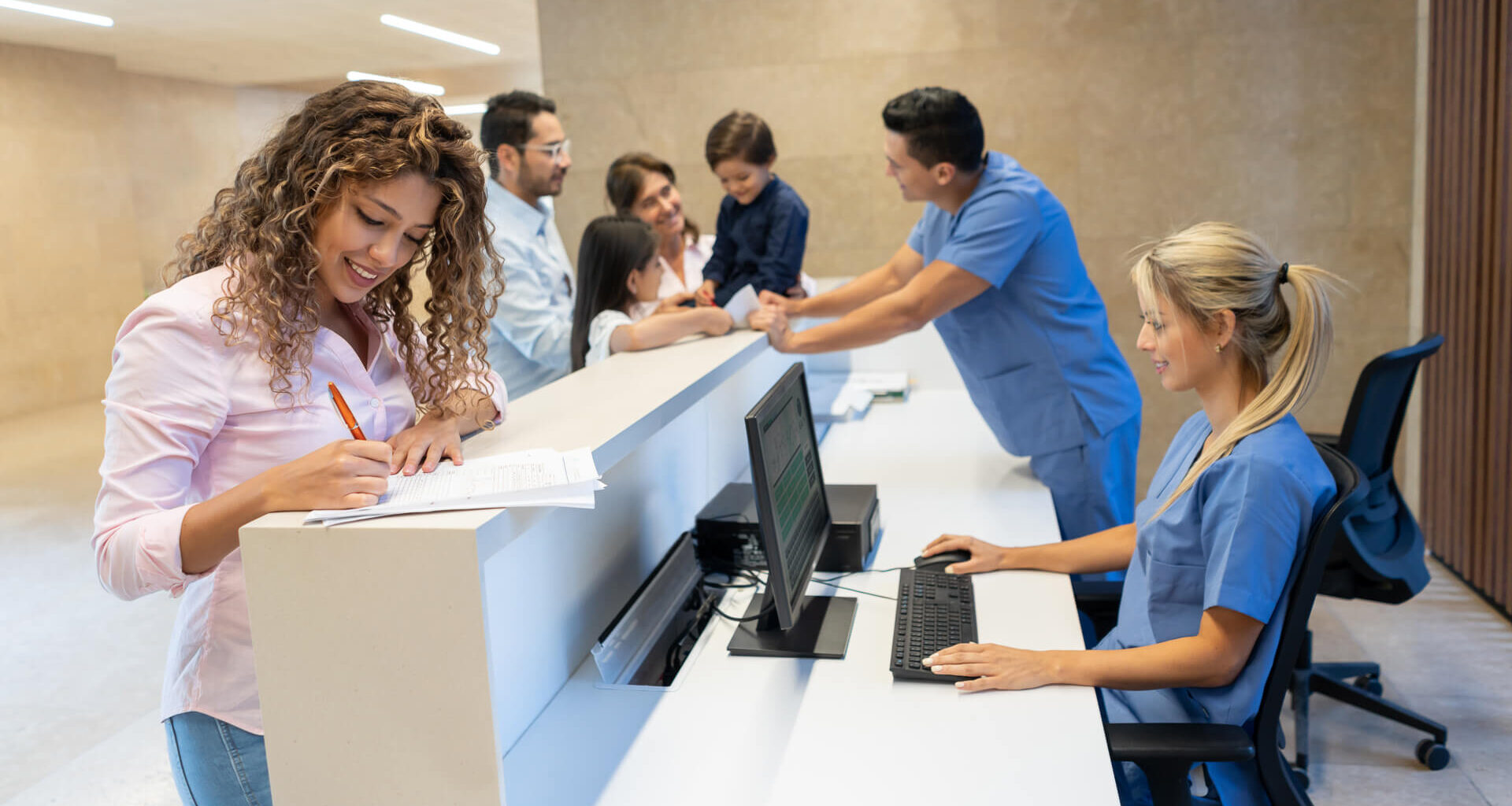 Beautiful latin american patient filling in a form at the hospital