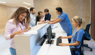 Beautiful latin american patient filling in a form at the hospital