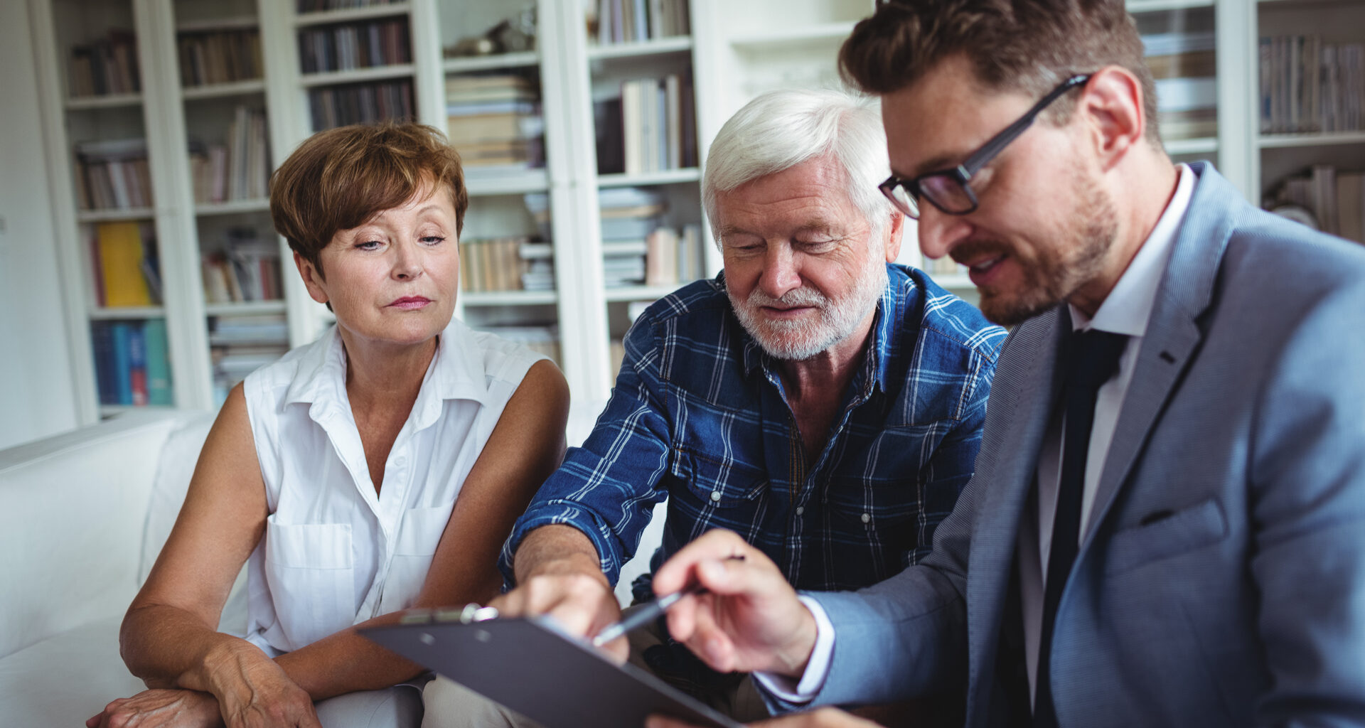 Senior couple speaking with a financial advisor about finances, retirement, investments and more.