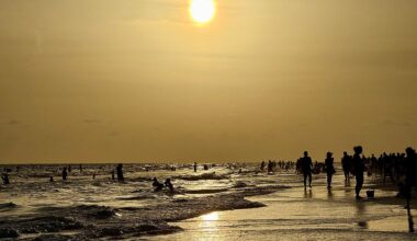 People walk on the beach at sunset at Siesta Beach in Sarasota, Florida, on June 6, 2025. At least 13 cases of Vibrio vulnificus infections have been reported in the state this summer, with four resulting in death.