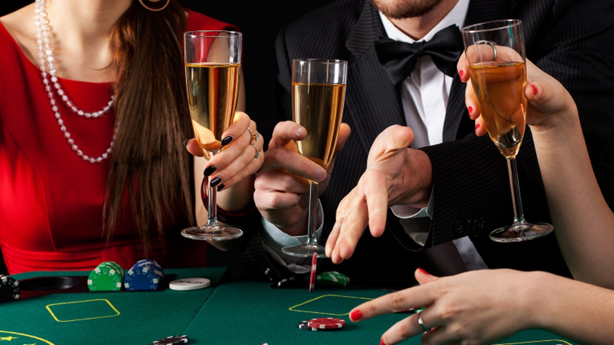 A couple of gamblers drinking a glass of champagne