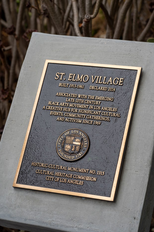 A plaque recognizing St. Elmo Village as a newly designated...