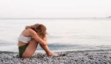 Stock image of sad woman on beach.
