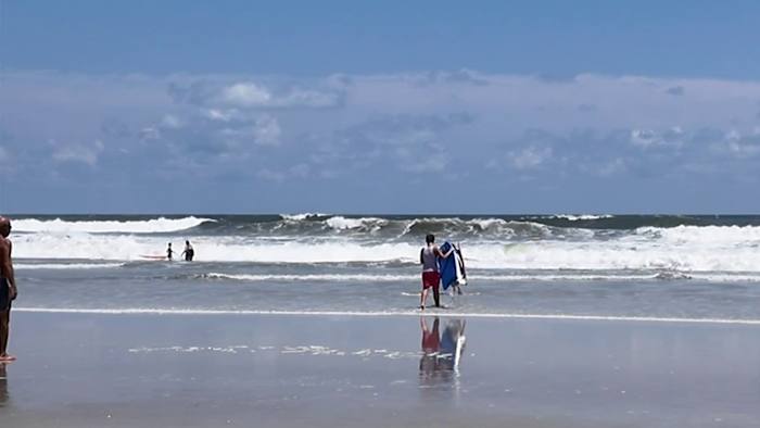 Jacksonville surfers brave beach waters to catch a wave despite rip current dangers