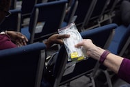 Teen gun violence town hall attendees pass around gun locks brought by law enforcement...