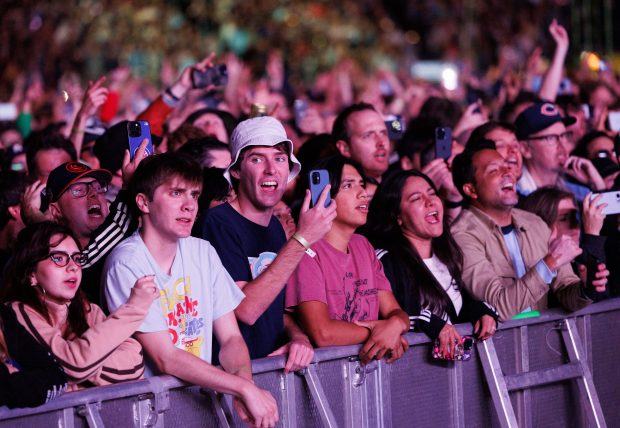 Fans watch Oasis perform at Soldier Field, Aug. 28, 2025,...