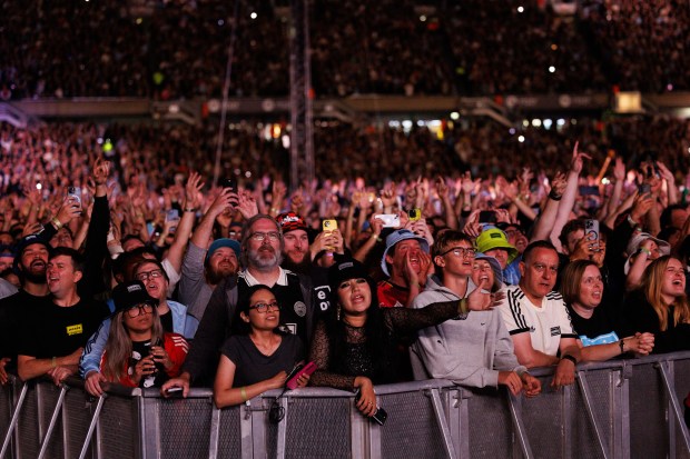 Fans watch Oasis perform at Soldier Field on Aug. 28,...