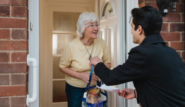 Teenage boy is delivering groceries to his grandmother.