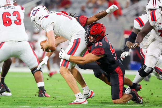 San Diego State's August Salvati sacks Stony Brook quarterback Casey Case during the first half at Snapdragon Stadium on Thursday, Aug. 28, 2025 in San Diego, CA. (Meg McLaughlin / The San Diego Union-Tribune)