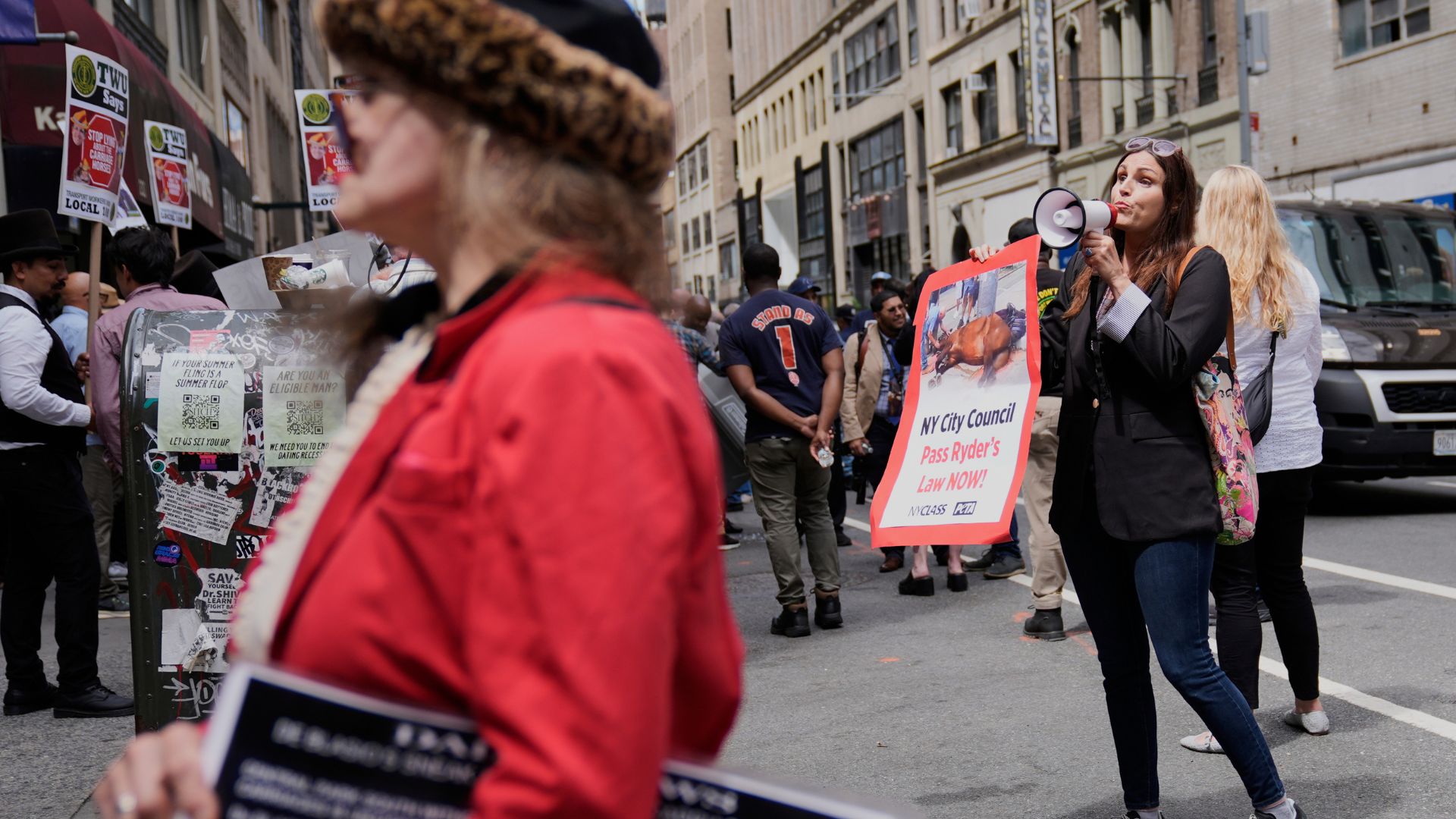 Edita Birnkrant, executive director of NYCLASS, right, an anti-horse carriage organization, shows up to a rally held by carriage drivers and their supporters in NY, Aug. 19, 2025.