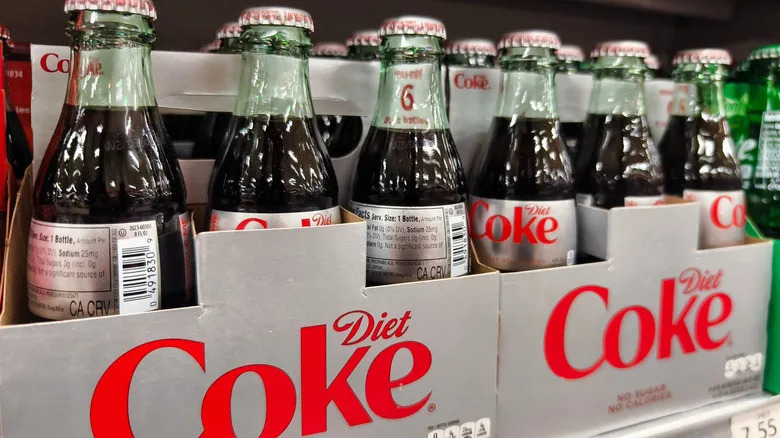 Two six-packs of Diet Coke on a store shelf