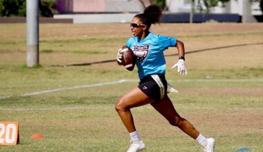 Cydeni Carter, sprinting with a football in a Phoenix Gay Flag Football League game, said she enjoys the league because there are “people who are around me who are just like me.” (Photo courtesy of Steph Ramos/Oro Hour Photos)