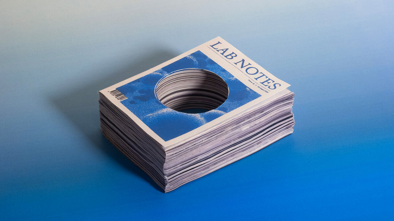 A stack of science journals with a big hole cut through the middle of them